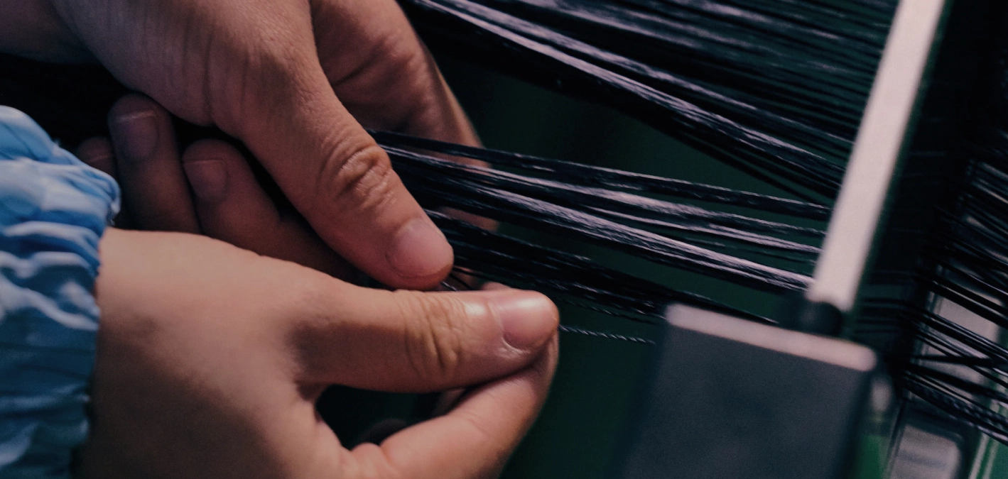 Aramid fibers being guided by hand