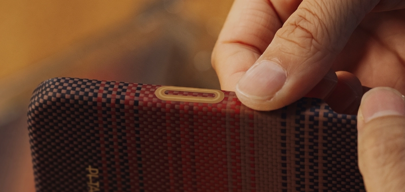 A finger using a flush PitaTap button on a woven case