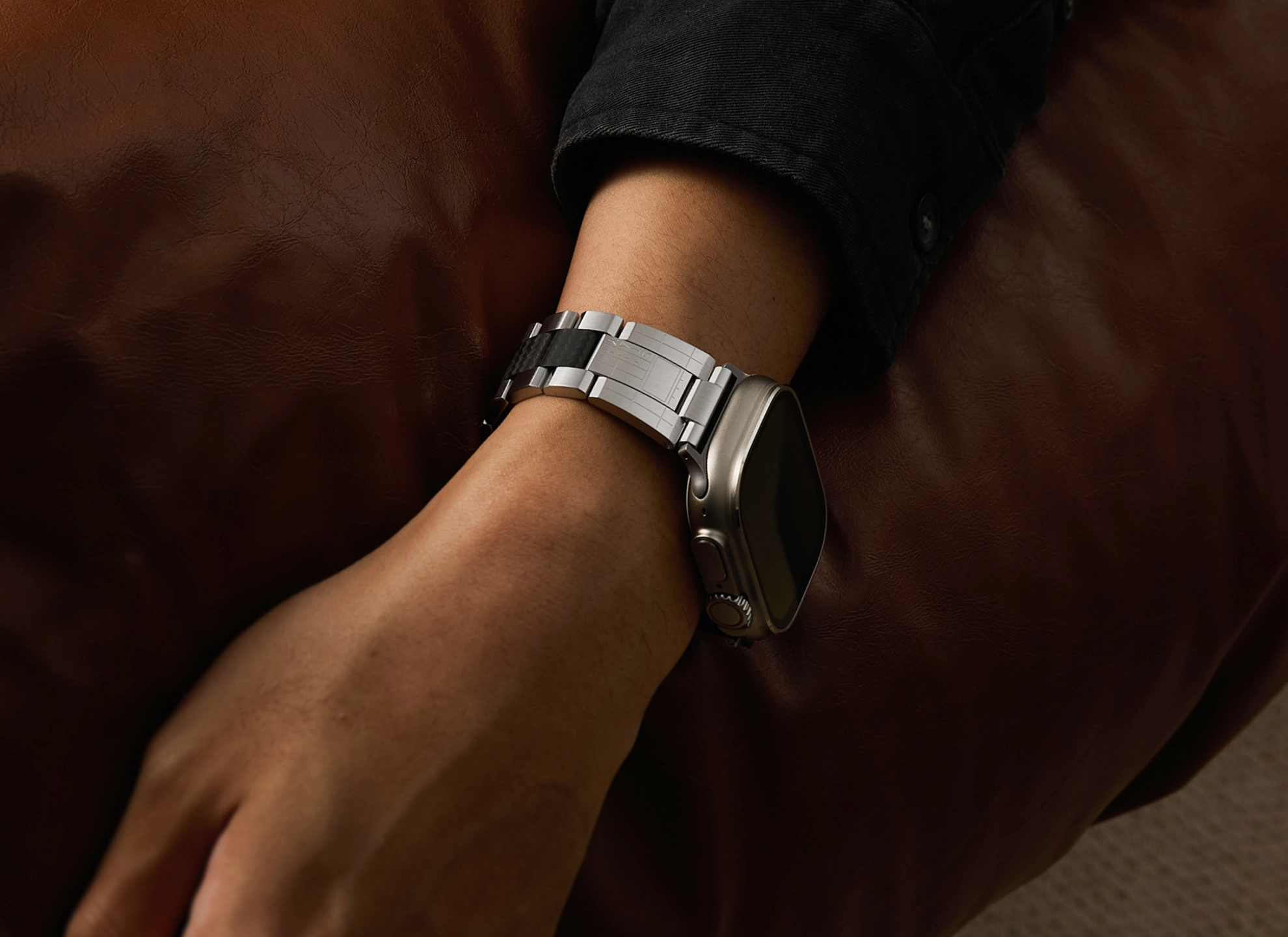 TARQ Temporal Vessel bracelet worn on a leather seat